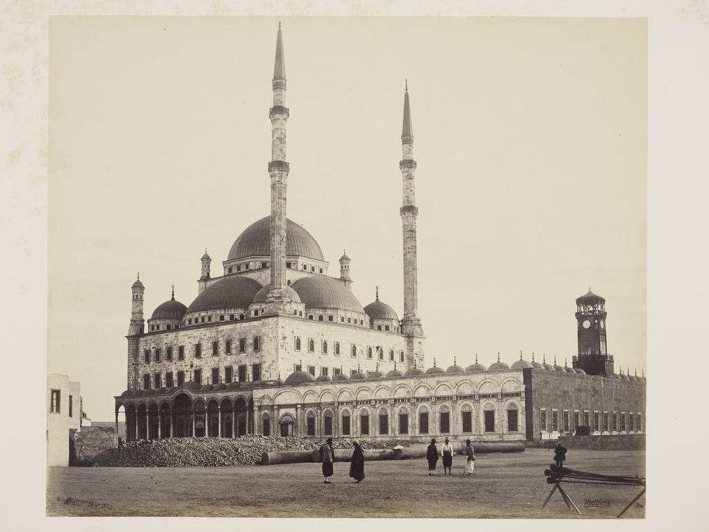 View of Mosque of Mohammed Ali in Cairo, Egypt. Alabaster building seen across square, with 2 tall minarets centre. Single row of columns supporting round arches lining court, left.

The mosque was built in the Ottoman style between 1830 and 1848 for th