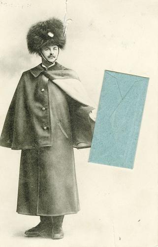 Postcard of a soldier holding an envelope