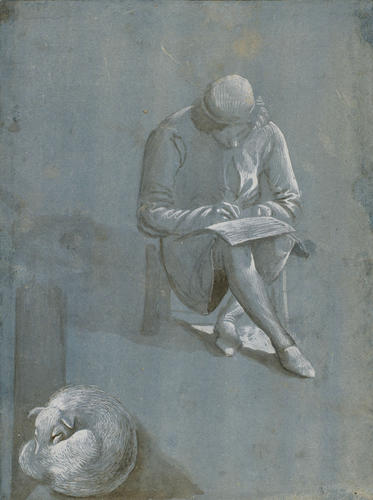A young man drawing, and a sleeping dog