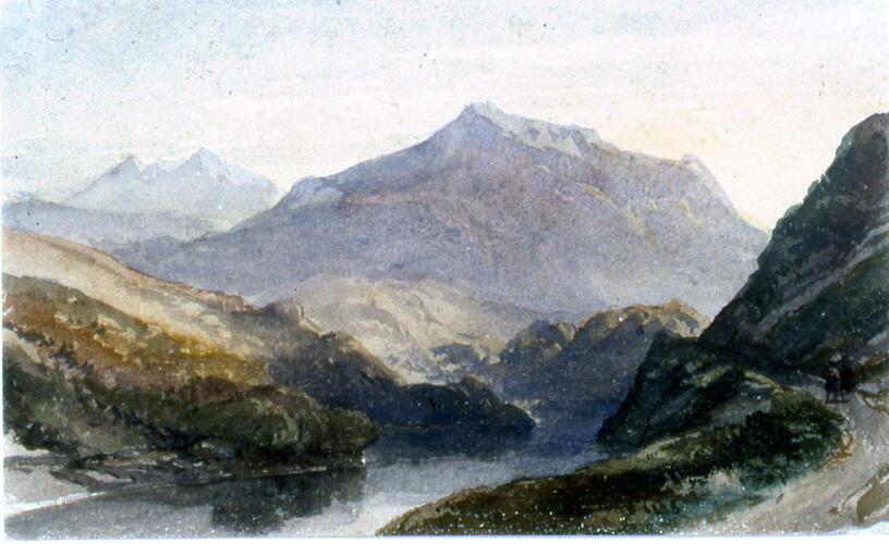 View of mountains with a loch in the foreground and a road on the right