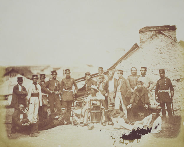 Group outside hut with seated ?officer in plain clothes [taken from contents list]. [Crimean War photographs by Robertson]