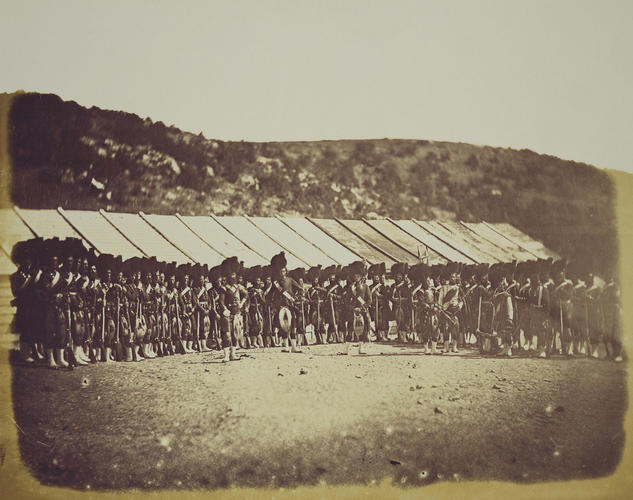 Highland Regiment in front of row of huts [taken from contents list]. [Crimean War photographs by Robertson]