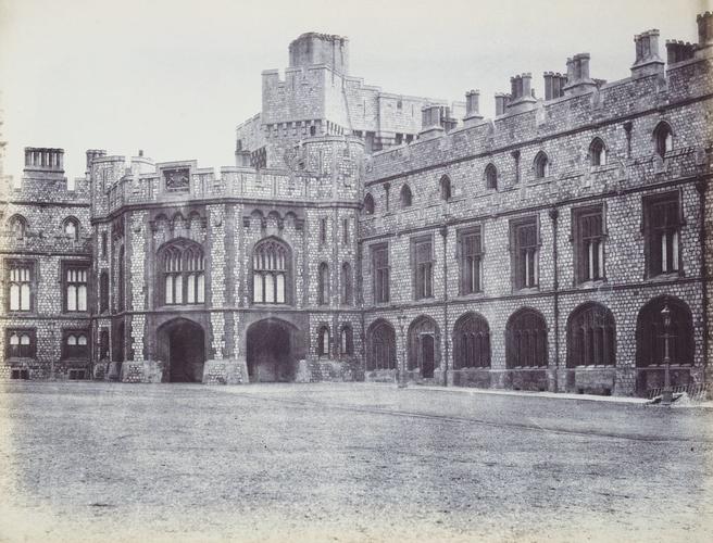 View of the Sovereign's entrance in the Quadrangle, Windsor Castle, to the right exterior of the Private Apartments and the Grand Corridor. [Windsor Castle]