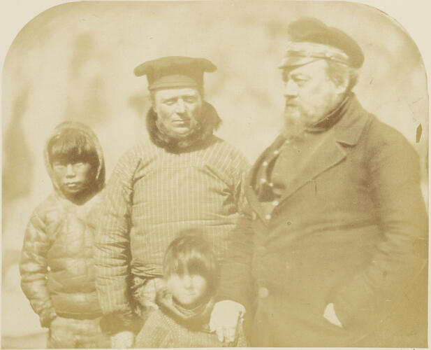 The Governor of Holsteinsborg, Jorgen Nielsen Møller with the Lieutenant Governor, Hans Elberg and Inuit boys
