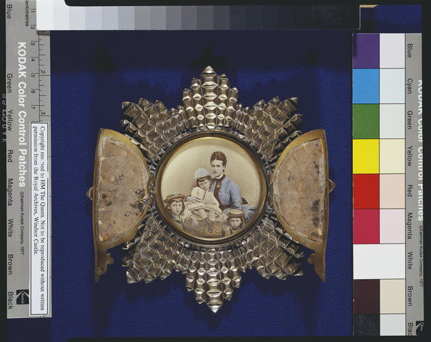 Tinted photograph of Alexandra, Princess of Wales, with her three eldest children in strut frame in the form of the Star of the Order of the Garter