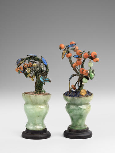 Pair of jade vases containing enamel plants Pair of jade vases containing enamel plants