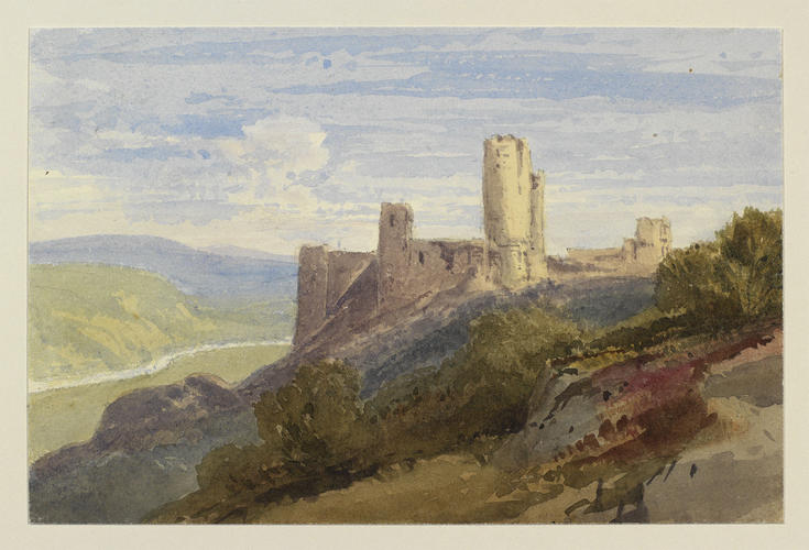 A ruined castle overlooking a valley