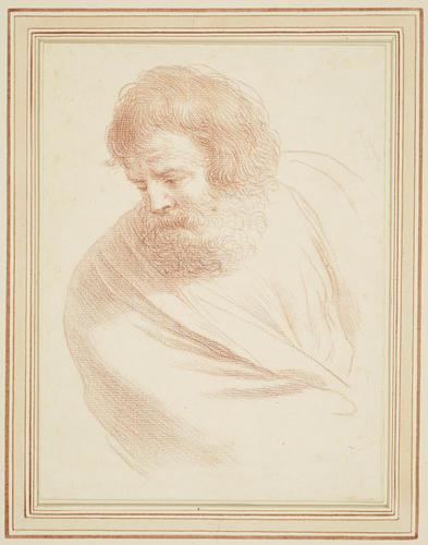 An old bearded man looking downwards