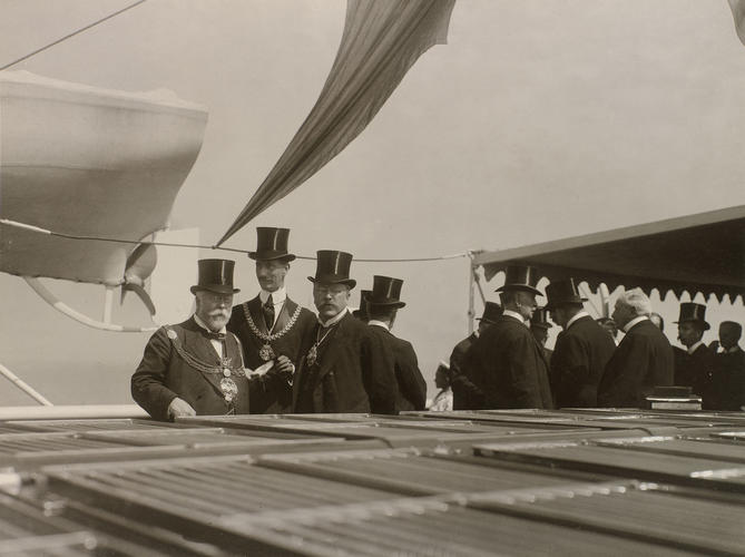 A group of men standing on the deck of the Russian Imperial Yacht Standart during the Cowes Regatta, 1909 A group of men standing on the deck of the Russian Imperial Yacht Standart during the Cowes Regatta, 1909