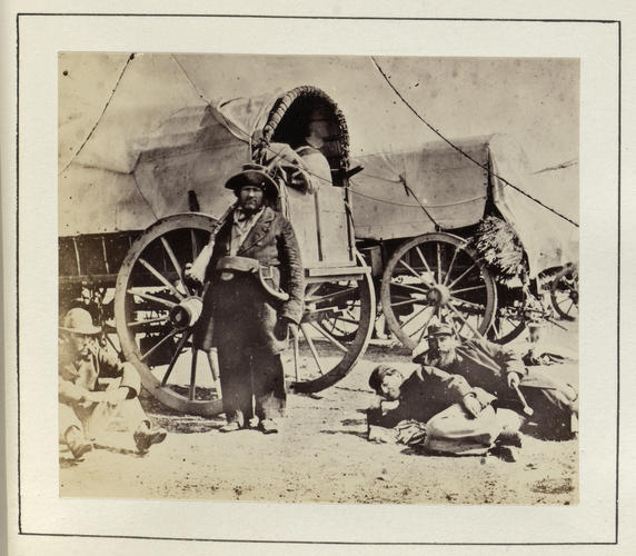 Members of the Royal party resting by the 'White Train' while camping by a river in South Africa