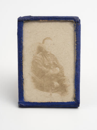 Miniature photographic portrait of unknown man wearing First World War uniform. [Queen Mary's Doll's House]