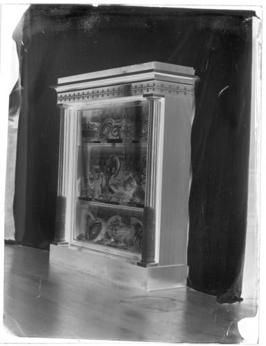 Glass plate negative showing a Marsh and Tatham ebony and ivory bookcase with porcelain, in the Grand Corridor, Windsor Castle Glass plate negative showing a Marsh and Tatham ebony and ivory bookcase with porcelain, in the Grand Corridor, Windsor Castle
