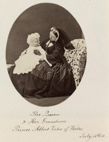 Photograph of Queen Victoria (1819-1901) seated with her grandson, Prince Albert Victor (1863-92), later the Duke of Clarence and Avondale