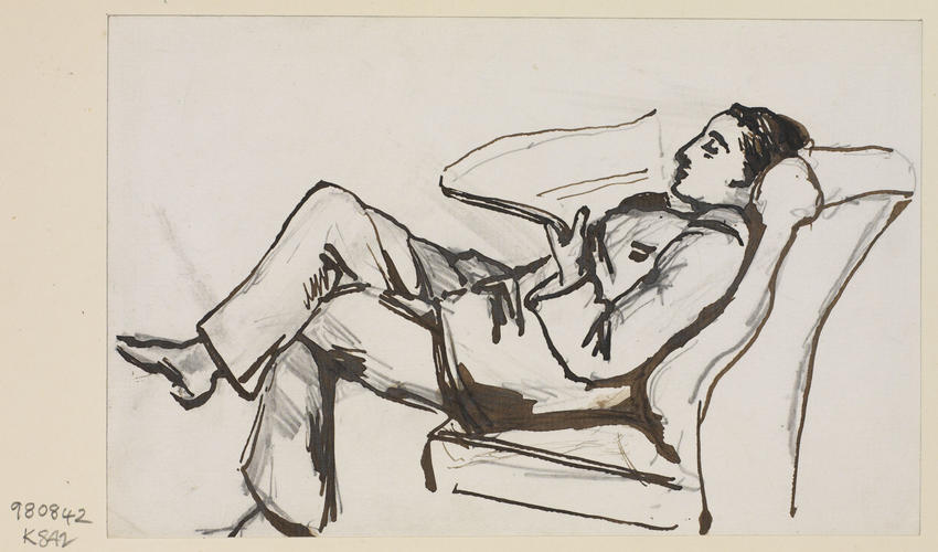 A man lounging in an armchair