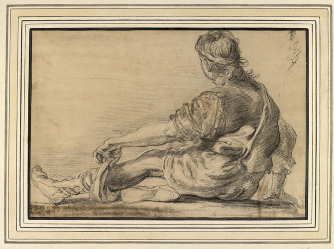 A seated youth seen from the back, pulling up his stockings