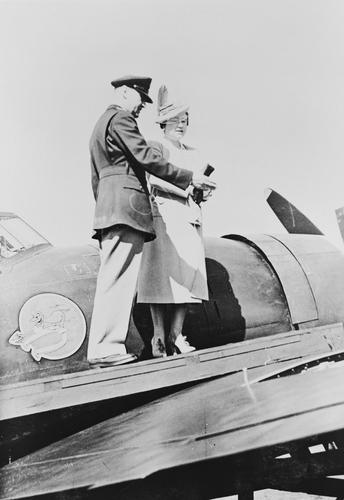 Lt General Devers with Queen Elizabeth on the wing of a P-47 Thunderbolt of the 83rd Fighter Squadron Lt General Devers with Queen Elizabeth on the wing of a P-47 Thunderbolt of the 83rd Fighter Squadron