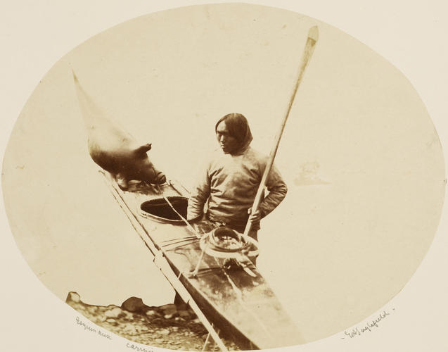 An Inuit man with a harpoon, inflated seal skin bladder and his Kyack