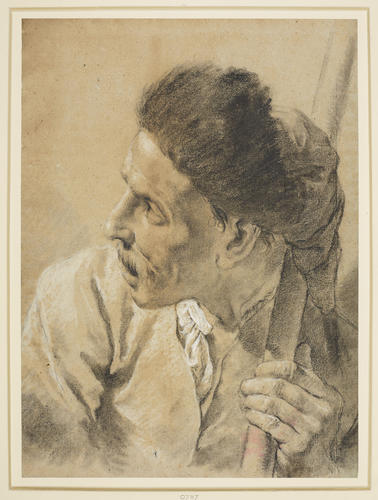 The head of a man in a fur cap holding a staff