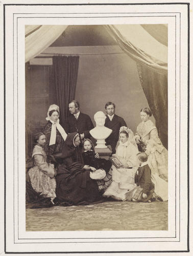Group portrait featuring Queen Victoria and her family arranged around a bust of Prince Albert