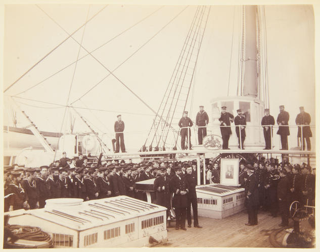 Photograph taken on board HMS Hector, twelve years guard ship at Cowes on the occasion of the Captain presenting an engraving of the Queen to the Officers and crew , February 1884. [Album: Photographi Photograph taken on board HMS Hector, twelve years guard ship at Cowes on the occasion of the Captain presenting an engraving of the Queen to the Officers and crew , February 1884. [Album: Photographi