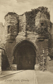 Master: Page 47 of Queen Mary's Album, volume 18, 20 June 1916 to 20 September 1918
Item: Gateway to castle, Lincoln