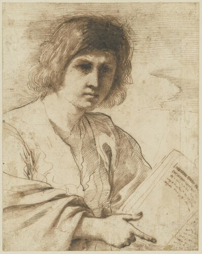 A young man pointing at a book A young man pointing at a book