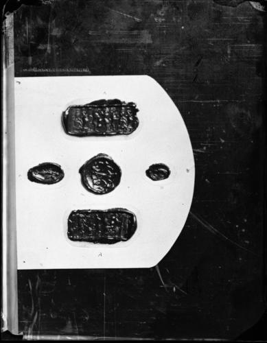 Glass plate negative of five red wax impressions from Babylonian seals and stones Glass plate negative of five red wax impressions from Babylonian seals and stones
