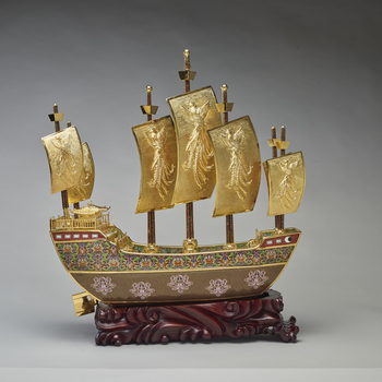 This is a model of the treasure ship sailed by the navigator and diplomat Zeng He of the Ming Dynasty. The prow of the ship is decorated with a dove and olive branch medallion, emblematic of peace, whilst the sides of the hull are decorated with elements 